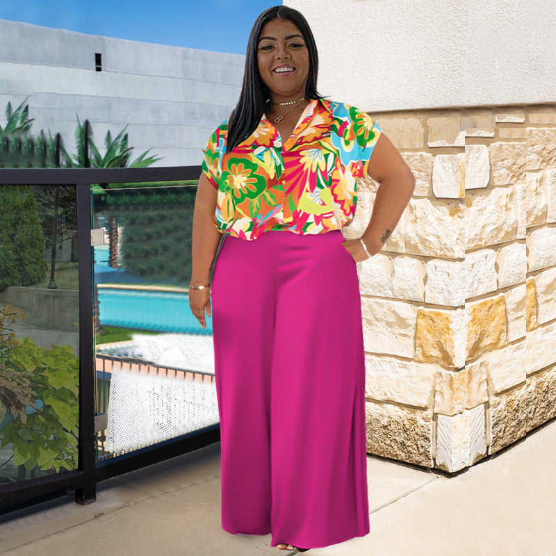 Plus size summer two-piece suit with floral collared top and solid high-rise trousers.