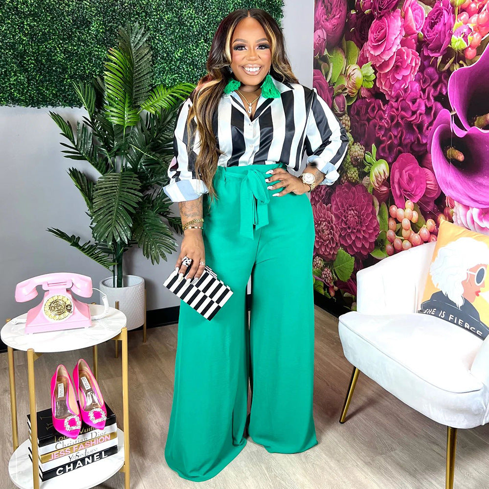 Printed elegant wide leg pants set with striped collared top and belted green pants.