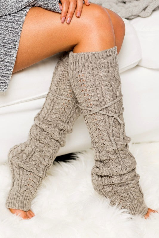 Cable knit long tie leg warmer with removable ties in cozy knit design.