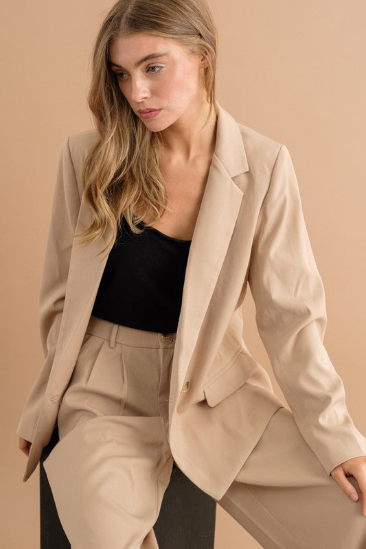 Double button blazer jacket with two front pockets, notch collar, and hip length, styled for formal wear.